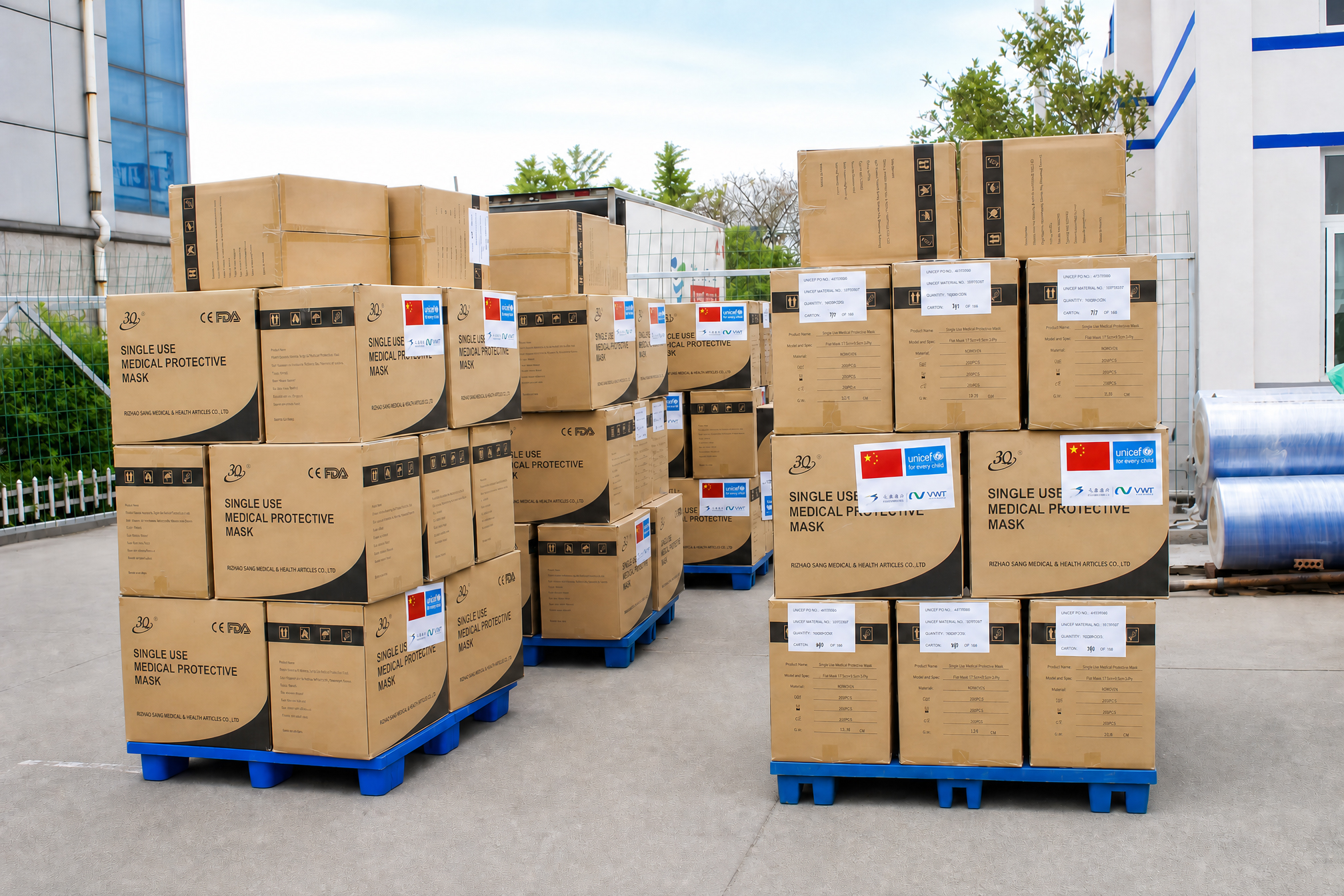 Sanqi team member preparing labeled cartons for a UNICEF medical mask donation shipment